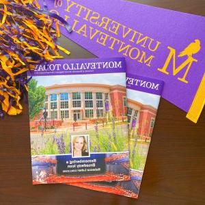 Two issues of Montevallo Today with a University of Montevallo banner and pom poms.